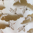 Decorative Japanese Chiyogami fabric pattern of cranes and clouds in gold and white