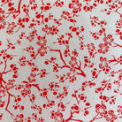 Floral pattern featuring red cherry blossom branches on light background in Japanese Chiyogami print