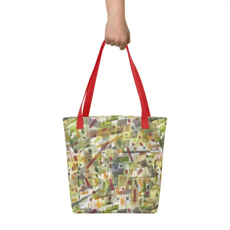 A woman showcasing a hand designed tote bag featuring a vibrant green abstract pattern