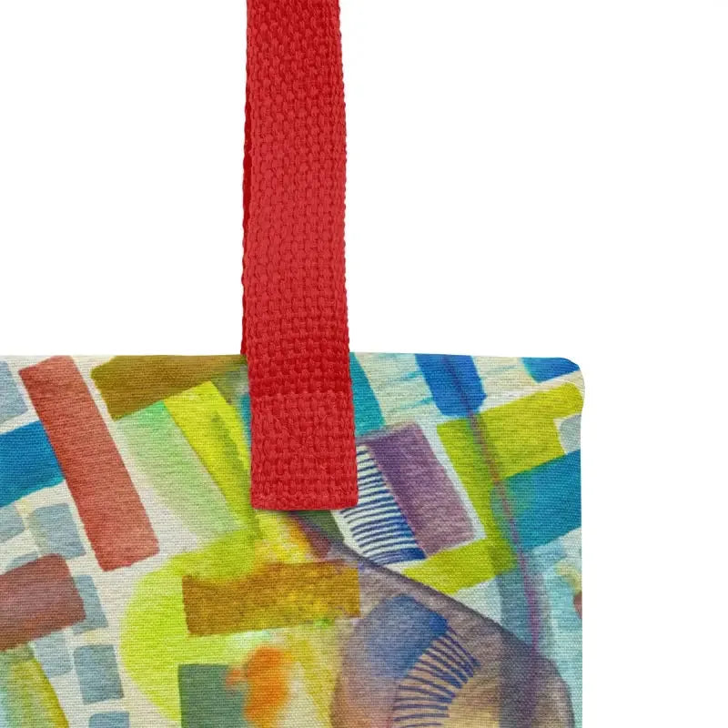 Colorful abstract painting on a red handle of a hand designed vibrant abstract tote bag